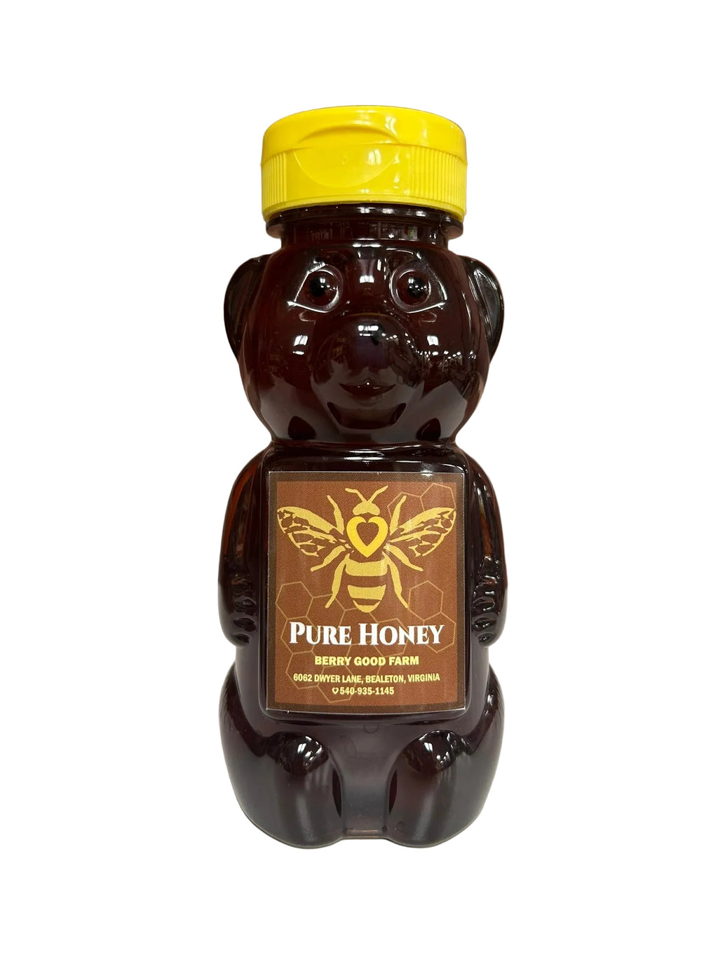 Honey bear bottle with yellow cap and label on a white surface 