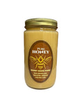 Jar of pure honey with a label on a white surface 