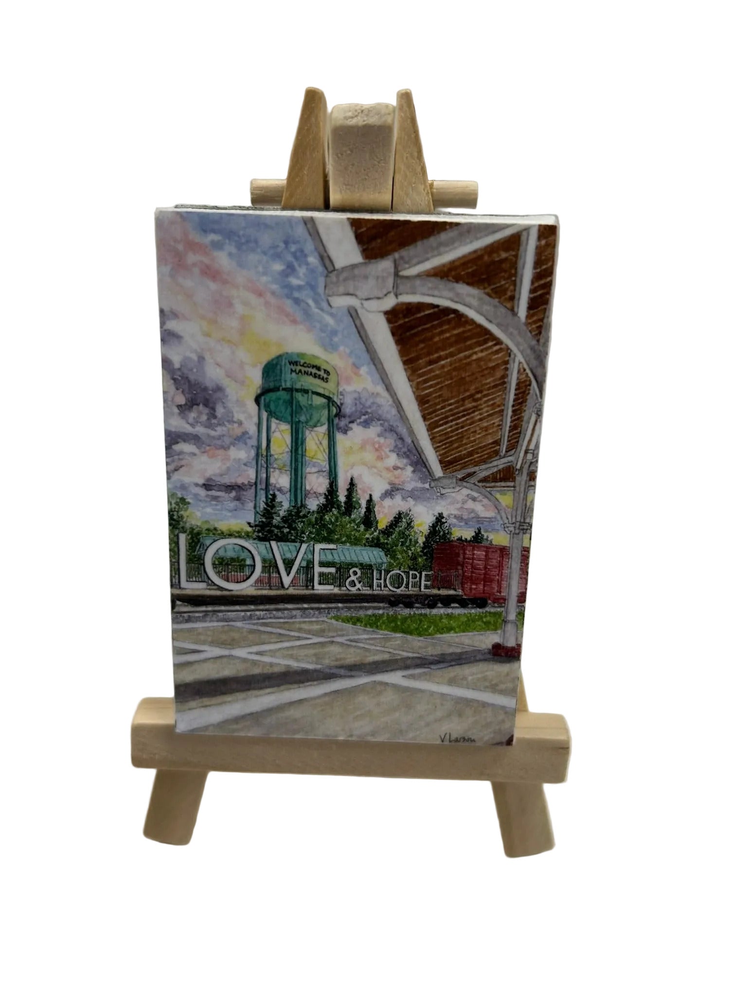 Small painting on a wooden easel with 'LOVE & HOPE' text
