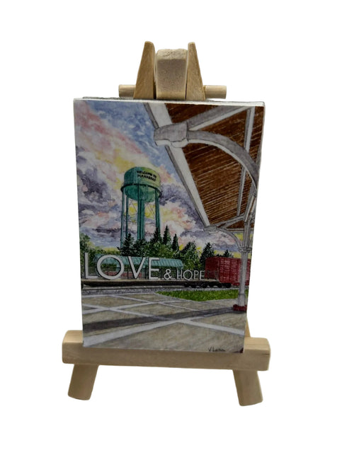 Small painting on a wooden easel with 'LOVE & HOPE' text