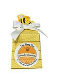 Honeycomb-shaped product with a bee design and white ribbon on a textured background, Lavender Lemonade Flavored