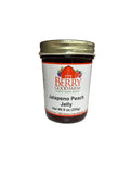 Jar of Jalapeno Peach Jelly from Berry Good Farm on a white surface 