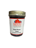 Jar of Berry Good Farm Red Plum Jelly on a white surface 